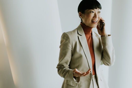 Businesswoman on a phone call in a modern office setting during the day