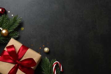 Christmas gift box and decorations on black background,  seasonal greeting