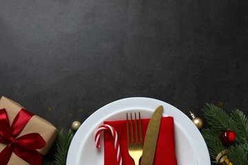 Festive Christmas and New Year's tablescape with pine branches, red ornaments and elegant...