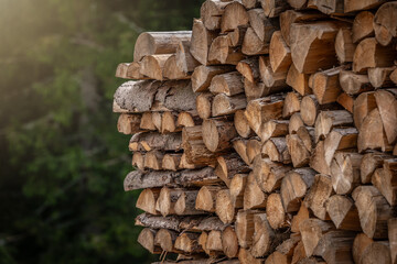 Wooden natural sawn logs as background, top view, flat lay. Wood texture. Firewood stack. 