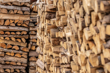 Wooden natural sawn logs as background, top view, flat lay. Wood texture. Firewood stack. 