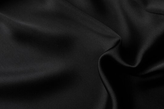 Black fabric cloth texture for background and design art work, beautiful crumpled pattern of silk or linen