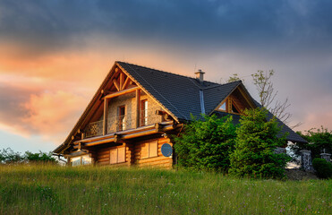 Obraz premium view of a wooden cottage above the village of Oravska Lesna