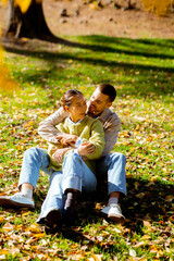 Fototapeta premium Joyful autumn day in the park with a couple enjoying nature's beauty and warm moments together
