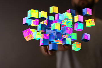 Digitally generated cubes concept represents innovation, technology, and interconnectedness. Man's hand interac