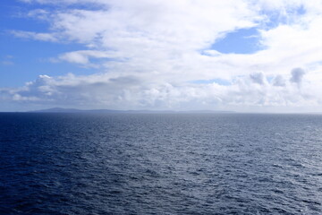 A distant view to the north coast of the Shetland Islands (Unst island, Muckle Flugga Lighthouse), Scotland