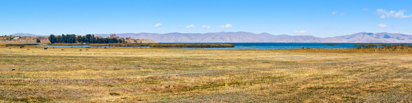 Panoramic view of the southwest shore of Lake Sevan and medieval monastery - Hayravank - in the background. Hayravank, Gegharkunik Province, Armenia