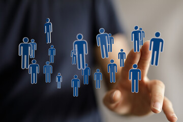 Abstract design with floating human icons near finger representing digital connection. Social network, teamwork