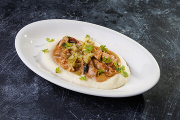 Creamy Mashed Potatoes With Chicken in Mushroom Sauce and Herb Garnish