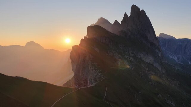 drone shot of sunrise on Seceda in the Dolomites, an iconic mountain in Dolomites, Italy, the Italian picturesque Pues Odle nature park in the Dolomite mountains. 