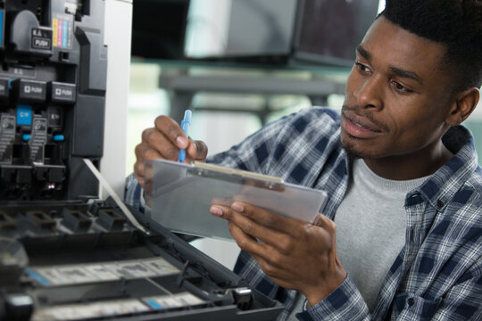 technician holding a clipboard for fixing printer