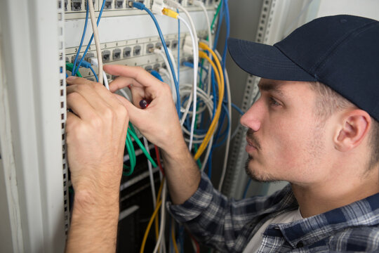 closeup of electrician engineer works with electric cable wires