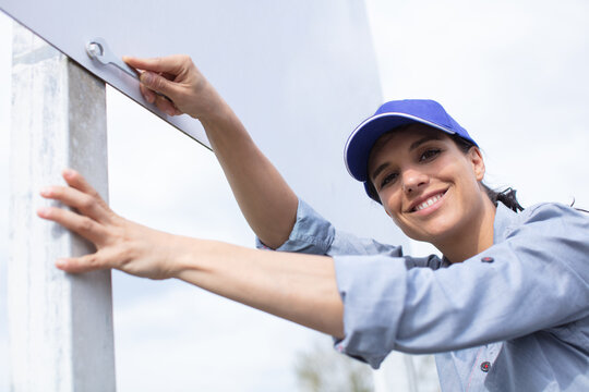 a happy female builder smiling outdoors