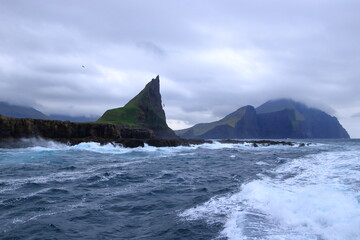 dramatic view of Drangarnir gate in front of Tindholmur in Vagar island, Faroe Islands, Denmark, north atlantic ocean