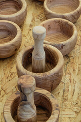 Handcrafted wooden mortars and pestles on display at a local market showcasing traditional craftsmanship from artisans