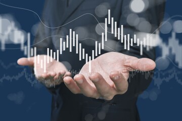 Businessman analyzing trading graph, finance background.