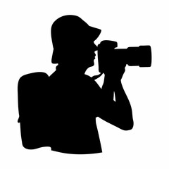 Silhouette of a photographer with a camera, hat and a backpack