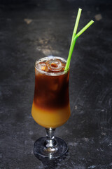 Iced Coffee Layered Drink in Glass with Green Straws