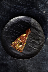 Rich Chocolate Cake Slice With Pistachio Cream Layer And Nut Crumble