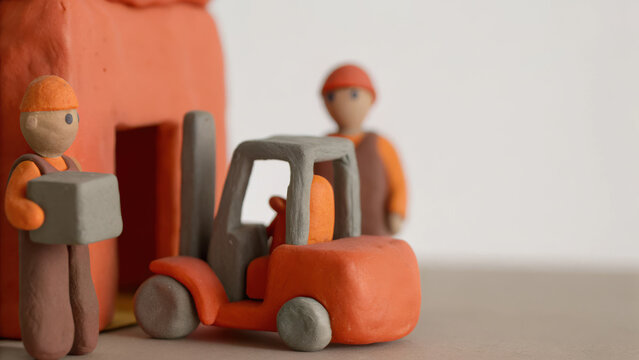 Mini clay forklift and worker figures in distribution warehouse scene showing teamwork and logistics concept - Powered by Adobe