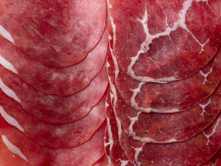 Raw marbled beef texture, thin slices arranged in layers