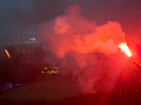 Uliczna demonstracja, ludzie, tłum, flagi, race, dym. Warszawa, Stadion Narodowy.  Miejsce na tekst.	