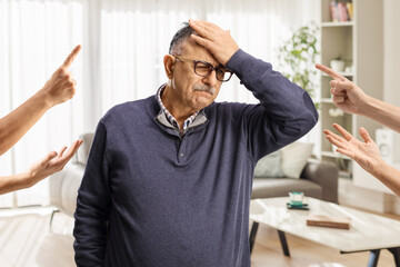 People reprimanding a guilty mature man