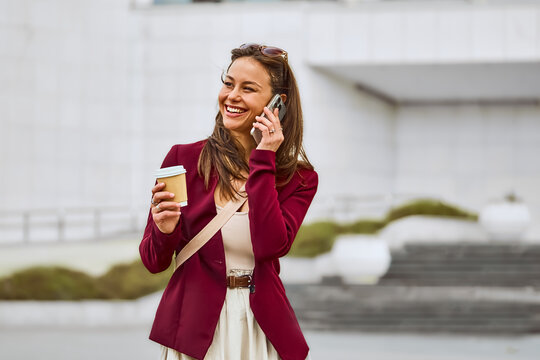 Latin smiling woman talking on phone. Professional and creative designer on a call for work discussion and planning