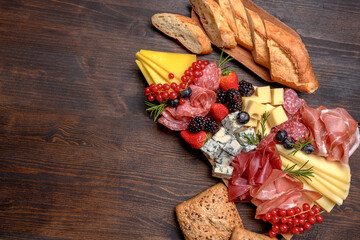 Party charcuterie board italian food antipasti prosciutto ham, salami and cheese appetizers served...