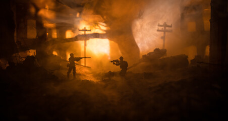 War Concept. Battle scene on war fog sky background, Fighting silhouettes Below Cloudy Skyline at night. City destroyed by war