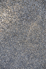 Vertical image at a close angle of a pavement made of crushed stone