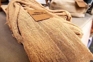 A brown, openwork fabric woven from walnut shells