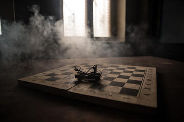 Medieval battle scene with two cannon on chessboard. Chess board game concept of business ideas and competition and strategy ideas Chess figures on a dark background with smoke and fog.