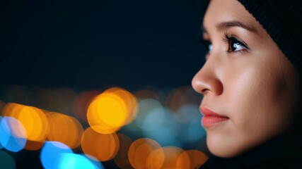 Film grain for color grading, close-up of a woman's face at night.
