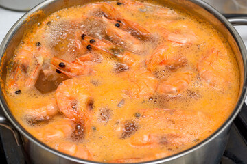Shrimp in a metal pot with boiling water.