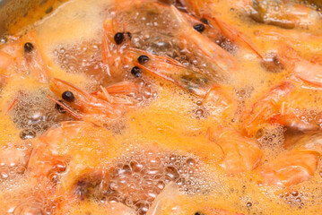Shrimp in boiling water as a food background or texture.