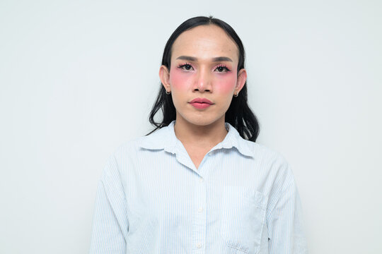 Portrait of a young Thai transgender person against white background