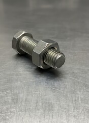 Close-up of a shiny, metallic bolt with a hexagonal nut