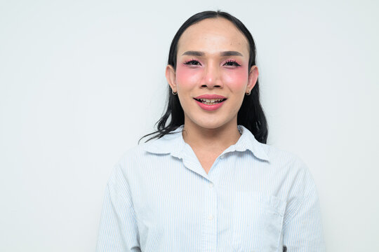 Portrait of a young Thai transgender person against white background