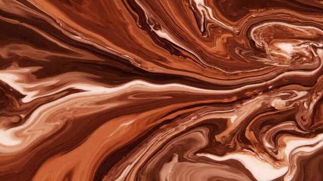 Delicious smooth dark liquid chocolate swirls and flowing cocoa waves create a creamy melted brown texture pattern for a sweet dessert food background