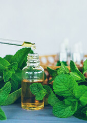 Peppermint essential oil in a bottle. Selective focus.