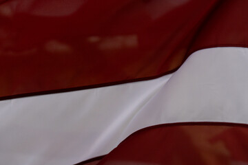 Latvian Flag Close-Up in Motion – Red and White National Symbol Abstract Detail