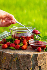 Strawberry jam in the garden. Selective focus.