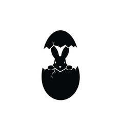 Easter bunny emerging from cracked egg silhouette