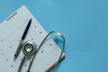 top view on stethoscope on calendar 2026 with over blue background for design about ads or banner of doctor appointment and health checkup following personal lifestyle concept