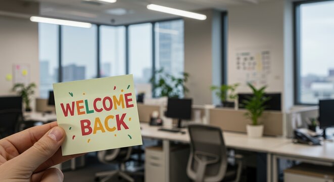 Office note with lettering WELCOME BACK, blurred office desks on background. Workspace with sign for collegues, greetings after sick leave or vacation. Selective focus
