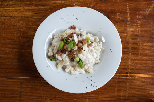 The national dish of Slovakia, Bryndzové Halušky, is a type of local potato dumplings (similar to gnocchi), mixed with traditional bryndza sheep cheese, and grated smoked sheep cheese, sprinkled on to