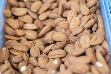 Raw almonds filling background for healthy eating concepts