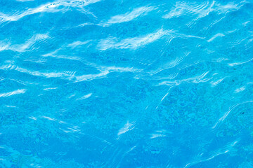 Clear blue water creating ripple reflections background
