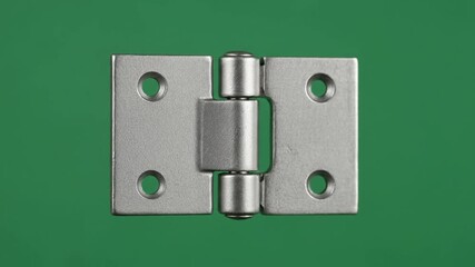 Close-up of a Metal Hinge on Green Background.